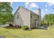 The backyard shows the deck and patio, featuring a lawn and tidy landscaping at 3129 Oak Ridge Ln, Loganville, GA 30052