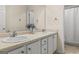 Well-lit bathroom featuring a double vanity with white sinks, a large mirror, and neutral color scheme at 3129 Oak Ridge Ln, Loganville, GA 30052