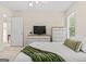 Cozy bedroom featuring neutral walls, a large window, and a comfortable bed with green throw at 3129 Oak Ridge Ln, Loganville, GA 30052