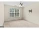 Neutral carpeted room with a ceiling fan and a tv mount installed on the wall at 3129 Oak Ridge Ln, Loganville, GA 30052