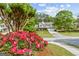 Beautiful two-story home with lush landscaping, a well-maintained lawn, and colorful flowers in the front yard at 3129 Oak Ridge Ln, Loganville, GA 30052