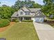 Charming two-story home featuring a well-manicured lawn, two-car garage, and inviting curb appeal at 3129 Oak Ridge Ln, Loganville, GA 30052