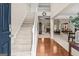 Welcoming foyer featuring a staircase, hardwood floors, and views into the living and dining spaces at 3129 Oak Ridge Ln, Loganville, GA 30052