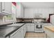Bright kitchen featuring white appliances, ample counter space, and natural light from a nearby window at 3129 Oak Ridge Ln, Loganville, GA 30052