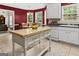 Well-lit kitchen with white cabinets, a center island, and a view to a separate dining area at 3129 Oak Ridge Ln, Loganville, GA 30052