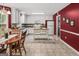 Bright kitchen with white cabinetry, center island, stainless steel appliances, and red accent wall at 3129 Oak Ridge Ln, Loganville, GA 30052