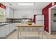 Well-lit kitchen with white cabinetry, stainless appliances, and a butcher block island with storage at 3129 Oak Ridge Ln, Loganville, GA 30052