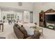 Open-concept living room with plenty of natural light, neutral carpet, and view into dining area at 3129 Oak Ridge Ln, Loganville, GA 30052