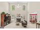 Comfortable living room features a fireplace, high ceilings, and ample natural light from large windows at 3129 Oak Ridge Ln, Loganville, GA 30052