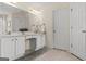 Well-lit main bathroom with double sinks, vanity area, and a neutral color palette at 3129 Oak Ridge Ln, Loganville, GA 30052