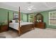 Spacious main bedroom featuring a four-poster bed, neutral carpet, and lots of natural light at 3129 Oak Ridge Ln, Loganville, GA 30052