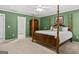 Another view of the spacious main bedroom with a four-poster bed and neutral carpet at 3129 Oak Ridge Ln, Loganville, GA 30052