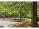 Community pavilion featuring brick columns, picnic tables, and a grill in a wooded setting at 3129 Oak Ridge Ln, Loganville, GA 30052