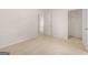 Bedroom with adjoining room featuring neutral carpet and paint, and white doors at 146 Oakchase Park Lane, Hampton, GA 30228