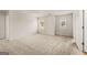 Bright bedroom featuring neutral carpet, trim and paint, and two windows with a view at 146 Oakchase Park Lane, Hampton, GA 30228