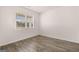 Bedroom with wood floors, bright window, and neutral decor at 146 Oakchase Park Lane, Hampton, GA 30228
