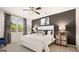 Serene bedroom featuring soft carpet, a ceiling fan, and an accent wall, providing a relaxing and comfortable retreat at 146 Oakchase Park Lane, Hampton, GA 30228