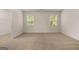 Comfortable bedroom featuring neutral carpet, bright windows, and a spacious layout at 146 Oakchase Park Lane, Hampton, GA 30228