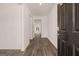 Inviting home hallway with sleek wood floors and bright, neutral paint at 146 Oakchase Park Lane, Hampton, GA 30228