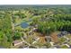 Aerial view of neighborhood homes and golf course with a lake at 2124 Gaddis Rd, Canton, GA 30115