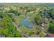 Aerial view of neighborhood homes and golf course with a lake at 2124 Gaddis Rd, Canton, GA 30115