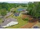 Scenic aerial view of property showcasing landscaped backyard, community golf course, and surrounding greenery at 2124 Gaddis Rd, Canton, GA 30115