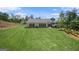 View of the back of house and backyard grass lawn at 2124 Gaddis Rd, Canton, GA 30115