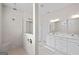 Bathroom showcasing a walk-in shower, double vanities, and modern white cabinets at 2124 Gaddis Rd, Canton, GA 30115