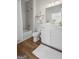 Modern bathroom with a sleek vanity, tub/shower combo, and neutral color palette with hardwood floors at 2124 Gaddis Rd, Canton, GA 30115