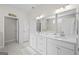 Bright bathroom featuring double vanities, marble countertops, and modern fixtures at 2124 Gaddis Rd, Canton, GA 30115