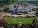 Stunning aerial view of the clubhouse with pool, golf carts, and expertly manicured grounds at 2124 Gaddis Rd, Canton, GA 30115