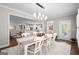 Formal dining room with a large table, decorative lighting, and views to the living room at 2124 Gaddis Rd, Canton, GA 30115