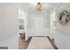 Elegant foyer with wainscoting, a decorative wreath, hardwood floors, and an eye-catching light fixture at 2124 Gaddis Rd, Canton, GA 30115