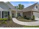 Charming home featuring manicured landscaping, stone accents, a curved walkway, and a welcoming front porch at 2124 Gaddis Rd, Canton, GA 30115