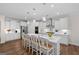 Modern kitchen featuring white cabinets, stainless steel appliances, a large island with seating, and pendant lighting at 2124 Gaddis Rd, Canton, GA 30115