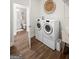 Convenient laundry room featuring a washer, dryer, and view into a bathroom at 2124 Gaddis Rd, Canton, GA 30115