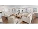 Open-concept living area with hardwood floors, comfortable seating, and seamless flow to the kitchen at 2124 Gaddis Rd, Canton, GA 30115