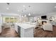 Open-concept living area with a modern island, fireplace, and lots of natural light at 2124 Gaddis Rd, Canton, GA 30115