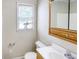 A bathroom featuring a toilet, sink, and a window with blinds at 1236 Stone Mountain Lithonia Rd, Lithonia, GA 30058