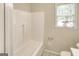 A bathroom featuring a bright white bath and shower combination and neutral paint at 1236 Stone Mountain Lithonia Rd, Lithonia, GA 30058