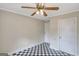 A bedroom featuring a black and white checkerboard floor pattern and a ceiling fan at 1236 Stone Mountain Lithonia Rd, Lithonia, GA 30058