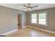 A bedroom featuring neutral paint, a ceiling fan, two windows, and a walk-in closet at 1236 Stone Mountain Lithonia Rd, Lithonia, GA 30058