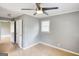 A bedroom featuring neutral paint, tile flooring, a window, and open doorways at 1236 Stone Mountain Lithonia Rd, Lithonia, GA 30058