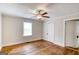 A bedroom featuring hardwood floors, neutral paint, a ceiling fan, and a window at 1236 Stone Mountain Lithonia Rd, Lithonia, GA 30058