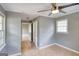 A bedroom featuring neutral paint, tile flooring, a window, and open doorways at 1236 Stone Mountain Lithonia Rd, Lithonia, GA 30058