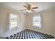 Bedroom featuring black and white tiled flooring and two windows with lace curtains at 1236 Stone Mountain Lithonia Rd, Lithonia, GA 30058