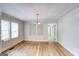 Bright dining room featuring hardwood floors, a chandelier, and natural light from large windows at 1236 Stone Mountain Lithonia Rd, Lithonia, GA 30058