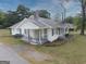 Cozy home features a porch, manicured lawn, and classic architectural style at 1236 Stone Mountain Lithonia Rd, Lithonia, GA 30058