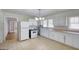 Functional kitchen with white cabinets, countertops, and a view to the dining area at 1236 Stone Mountain Lithonia Rd, Lithonia, GA 30058