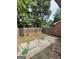This backyard features a concrete patio and a wood fence for privacy at 4712 Rockstile Way, Stone Mountain, GA 30083